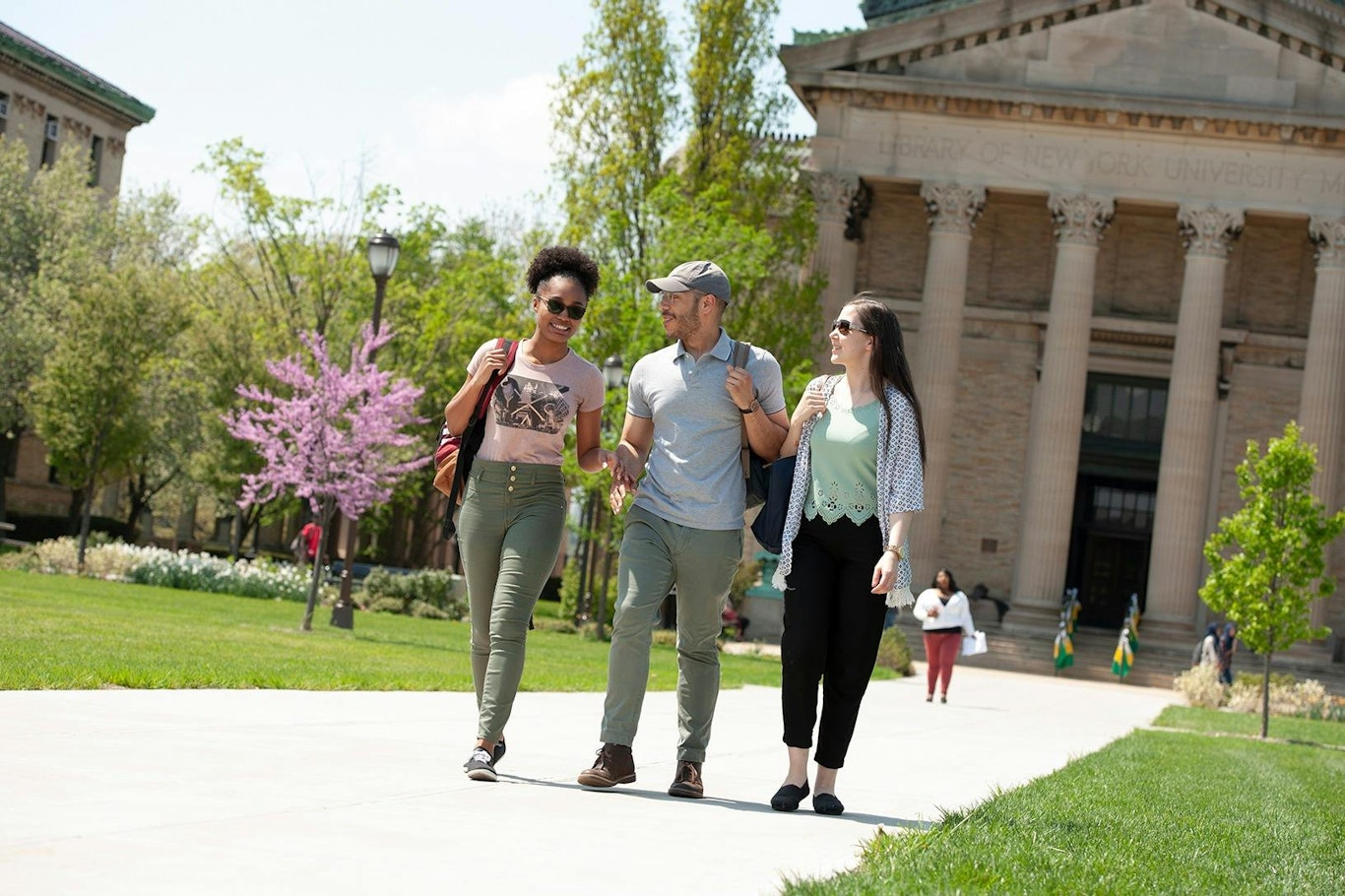 A group of students walking on a college campus