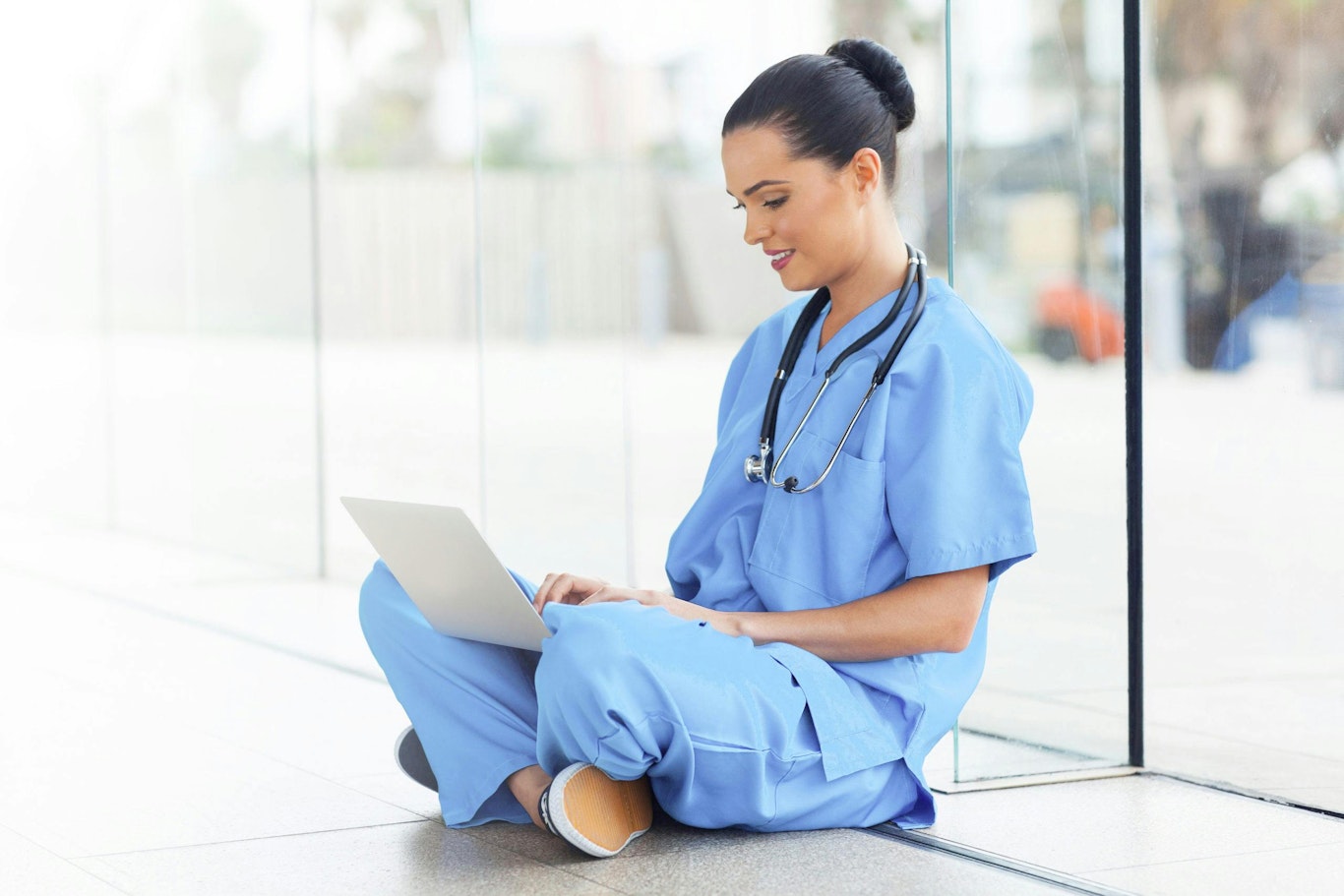 Medical professional sitting with laptop